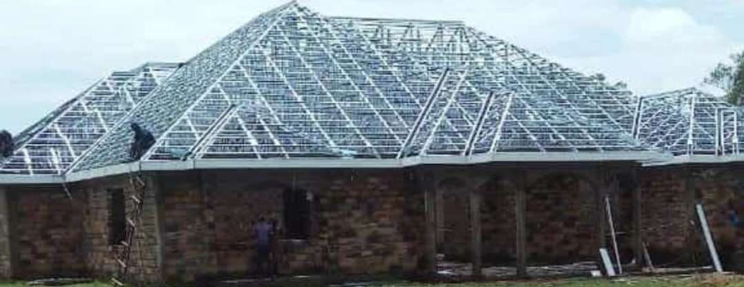Light gauge steel roof trusses over a masonry building